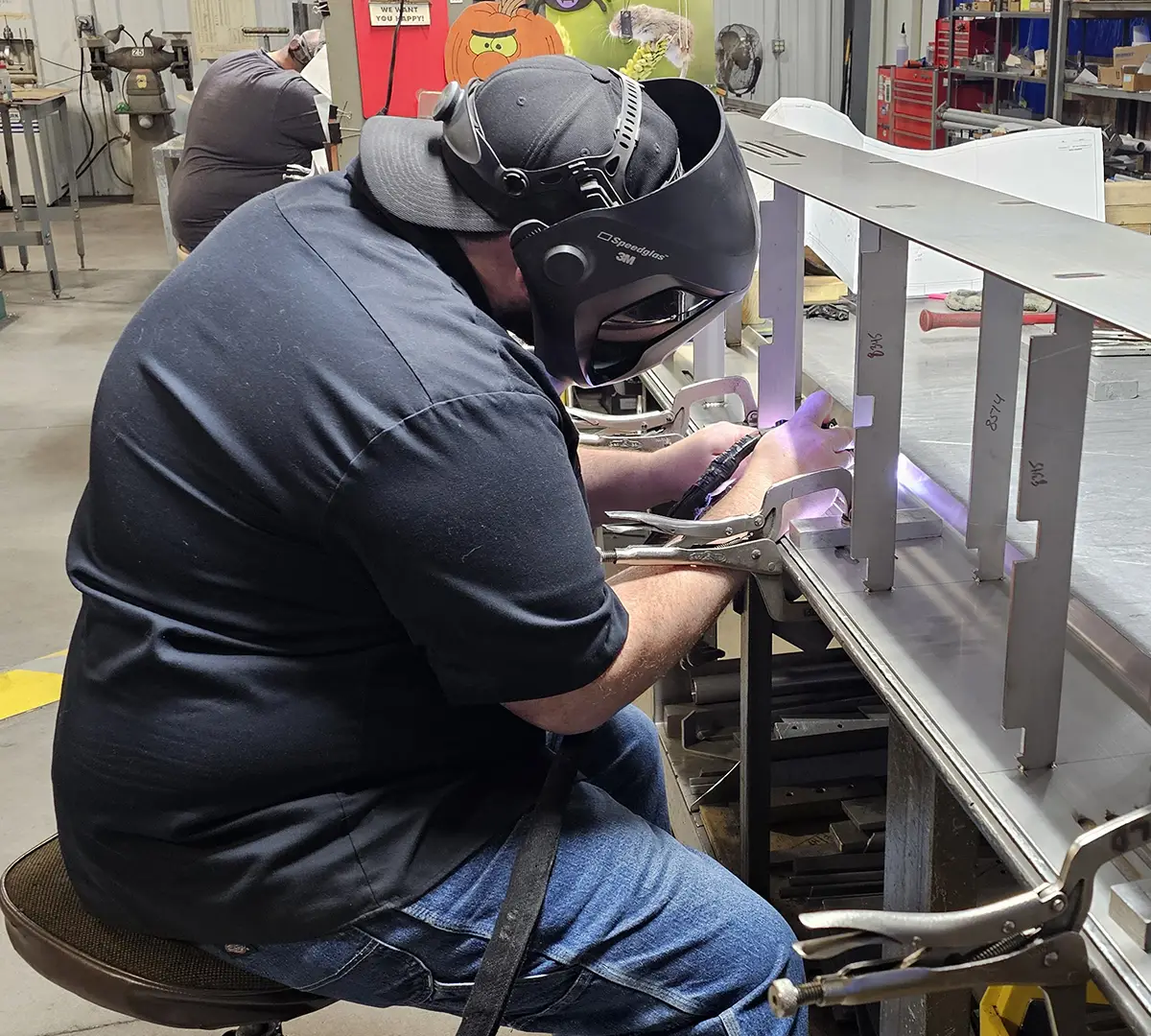 a welder working on a conveyor